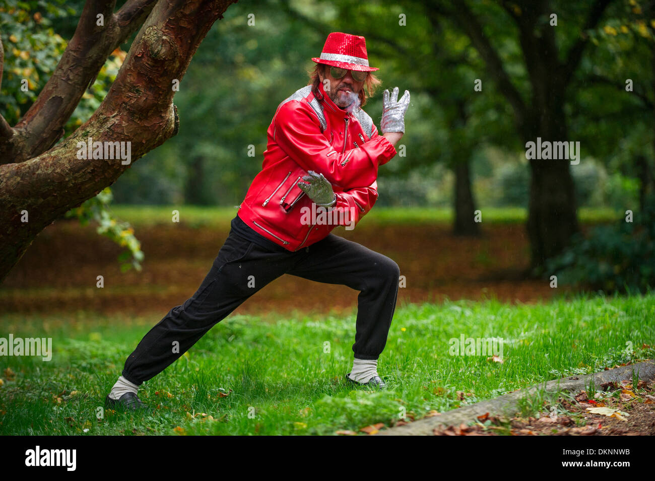 Un Michael Jackson impersonator in posa per una foto in Bute Park, Cardiff, mentre si fuma una sigaretta Foto Stock