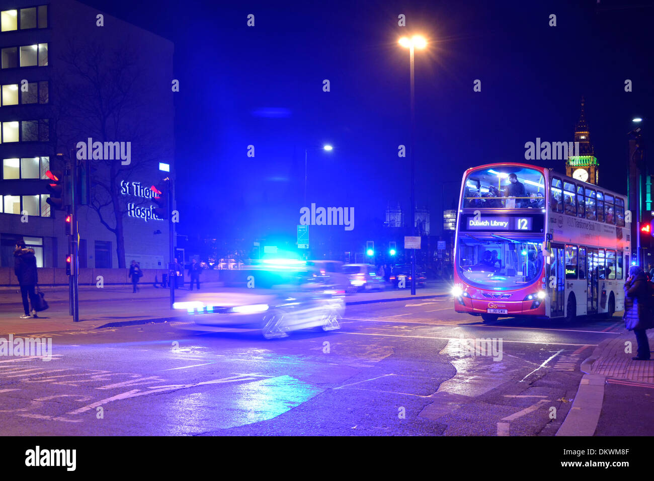 Motion Blur Metropolitan polizia auto blu luci riflessi illuminante notte cielo Londra autobus in attesa al semaforo rosso Westminster Bridge Inghilterra Foto Stock