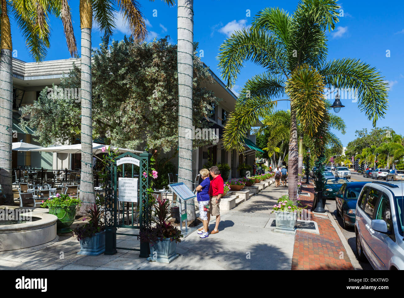 Coppia di mezza età guardando un menu al di fuori di un ristorante sulla Terza Strada Sud nel centro cittadino di Naples, costa del Golfo della Florida, Stati Uniti d'America Foto Stock