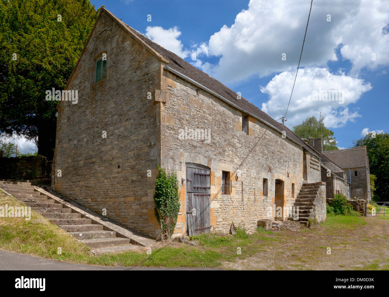 Antico in pietra a Cotswold fienile con colombaia, Hazelton, Gloucestershire, Inghilterra. Foto Stock