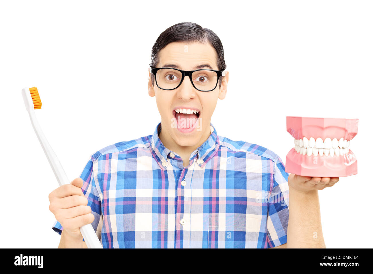 Guy tenendo una protesi realizzata in gesso e uno spazzolino da denti Foto Stock