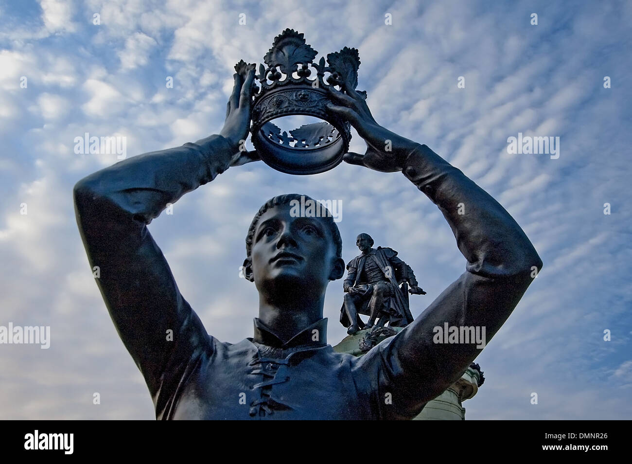 Frazione tenendo una corona aloft con William Shakespeare guardando sopra la sua spalla, parte del memoriale di gower statua in bancroft giardini, Stratford. Foto Stock