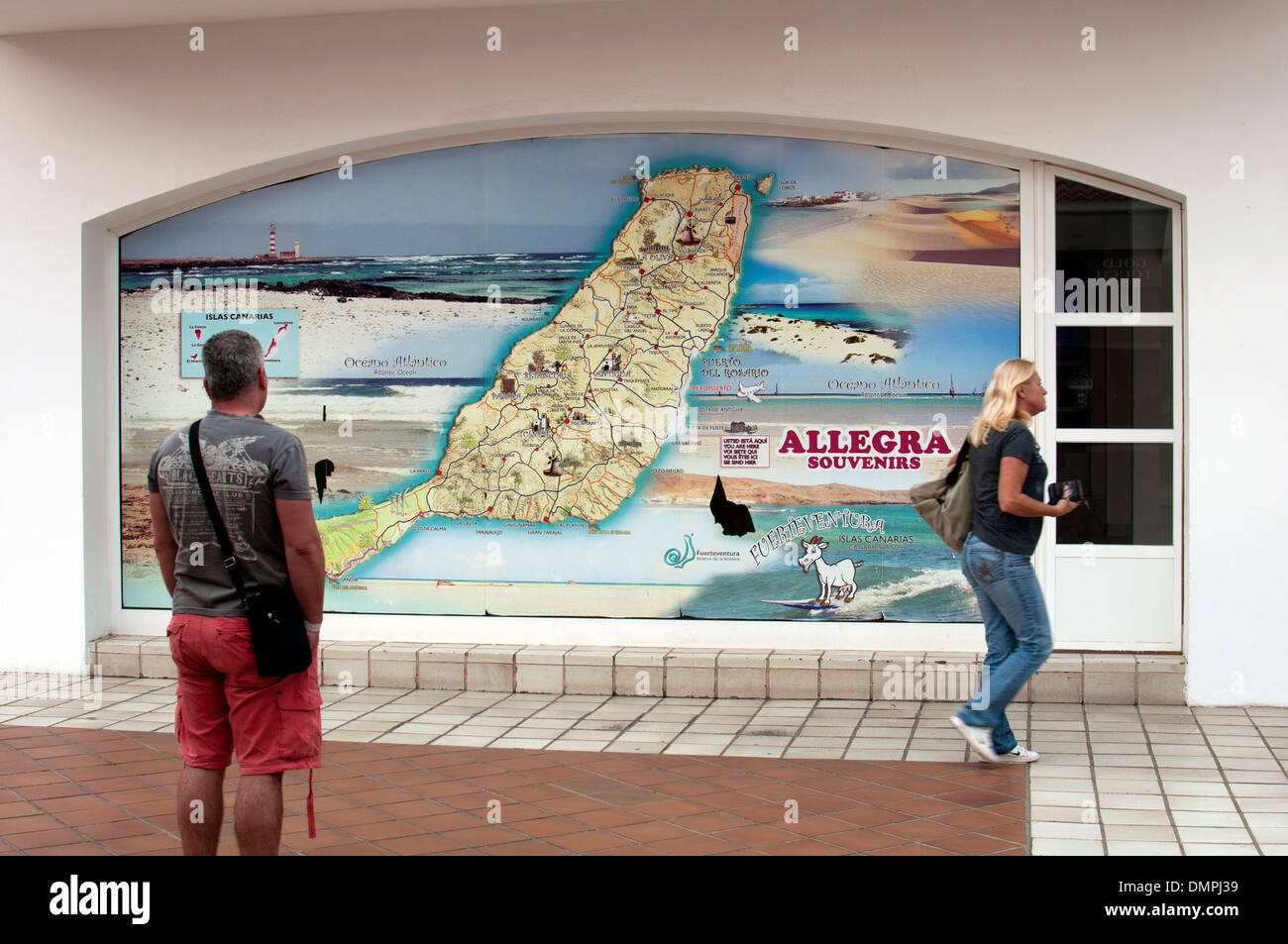Uomo che guarda la mappa di Fuerteventura su una parete, Caleta de Fuste, Fuerteventura, Isole Canarie. Foto Stock