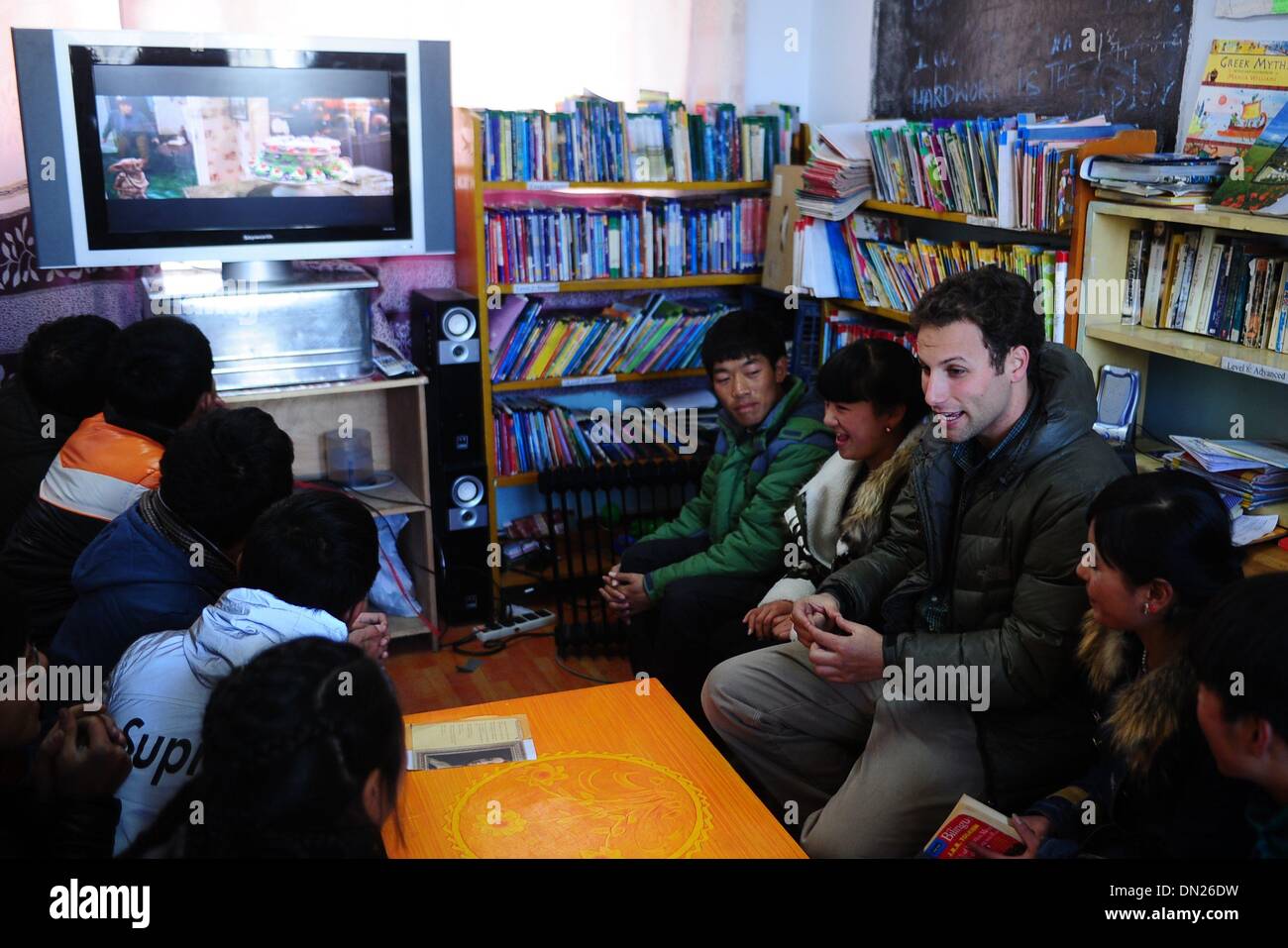 (131218) -- HUANGNAN, Dic 18, 2013 (Xinhua) -- Andrew guarda un film con gli studenti alla seconda Minzu Middle School in tibetano prefettura autonoma di Huangnan, a nord-ovest della Cina di Provincia di Qinghai, Dic 17, 2013. Il 29-anno-vecchio Andrew Frankel dall America ha sempre dimostrato interesse nella cultura tibetana. Nel 2012, egli ha lasciato la sua città natale di Qinghai e divenne un insegnante presso la scuola. Oltre a insegnare inglese classi, ha stabilito un inglese un angolo libri e un film club, la creazione di una migliore inglese-studiando atmosfera per studenti locali. " Mi piace stare con i miei studenti", Andrew ha detto come egli fou Foto Stock