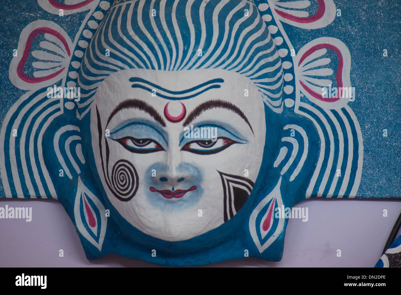 La lavorazione artigianale della maschera di carta del signore Shiva nei colori del bianco e del nero,blu, indicando benigna grazia di Dio. Foto Stock