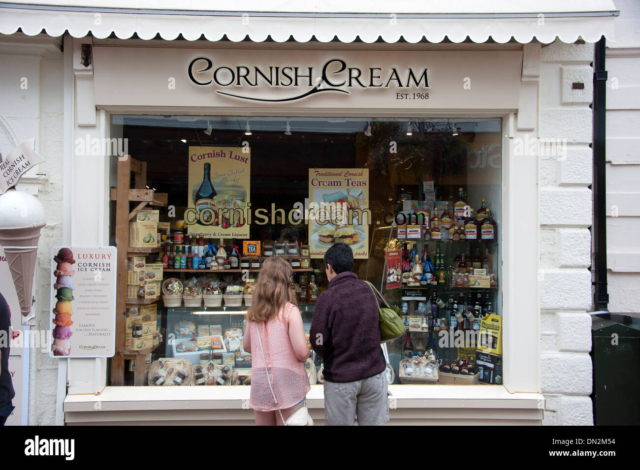 I turisti in cerca di Cornish Cream Vetrina Newquay Cornwall modello completamente rilasciato Foto Stock