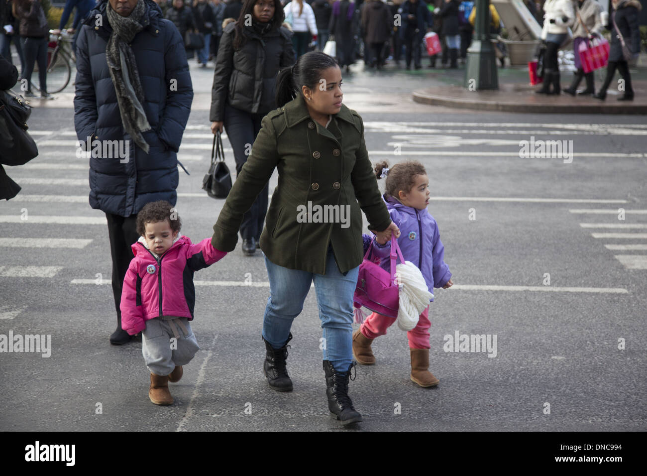 Madre con figli piccoli attraversando 34th Street in NYC. Foto Stock