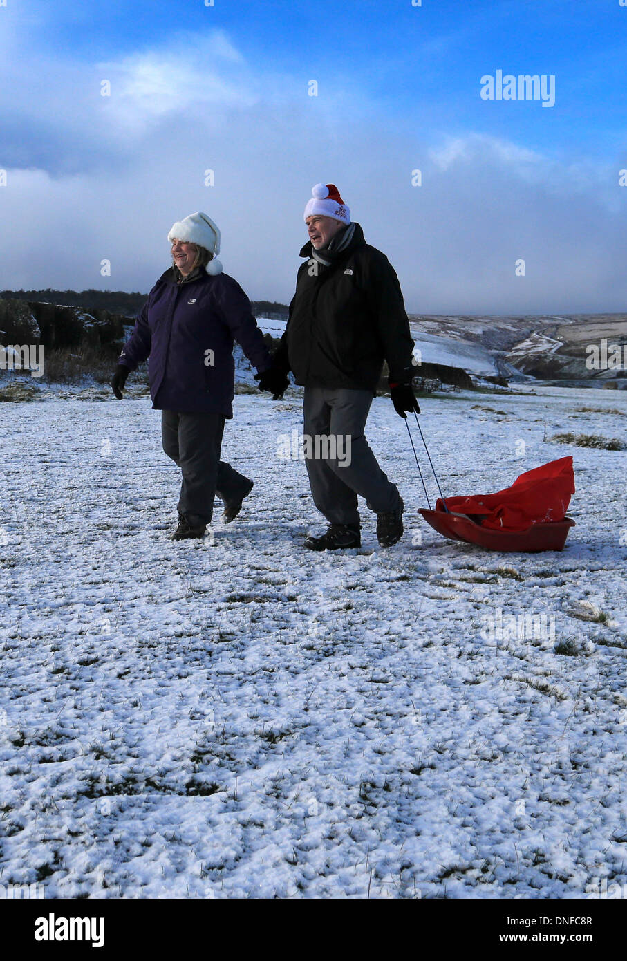 Buxton, Derbyshire, Regno Unito. 25 Dic, 2013. Un auto è recuperato da un pendio nevoso a seguito di uno scorrimento più di 150ft sul tetto al di fuori della A53 vicino a Buxton nel Derbyshire Peak District in snow, inizio il giorno di Natale. Credito: Joanne Roberts/Alamy Live News Foto Stock