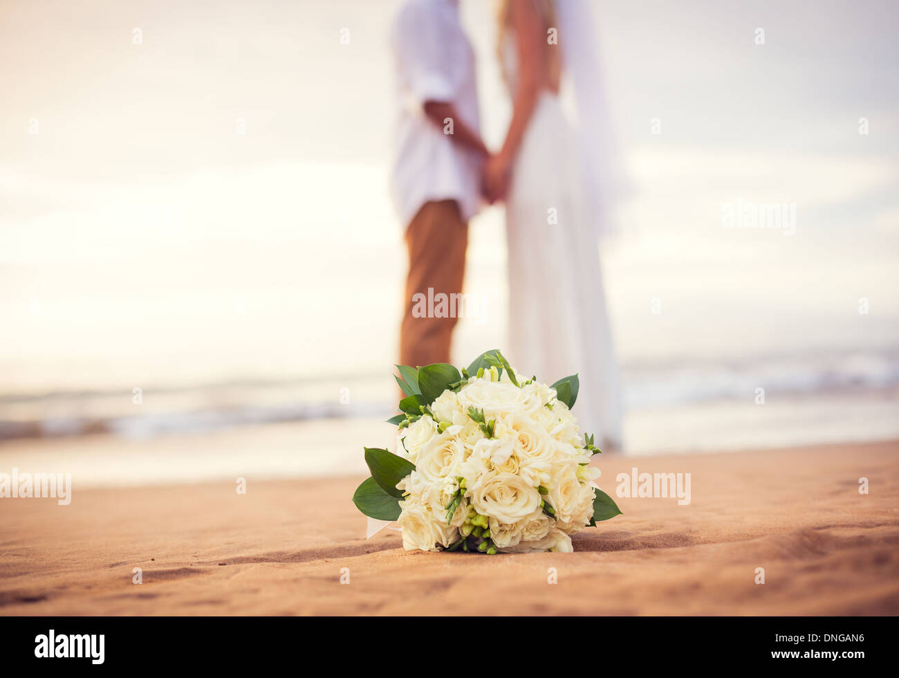 Appena una coppia sposata tenendo le mani sulla spiaggia, Hawaii matrimonio sulla spiaggia Foto Stock