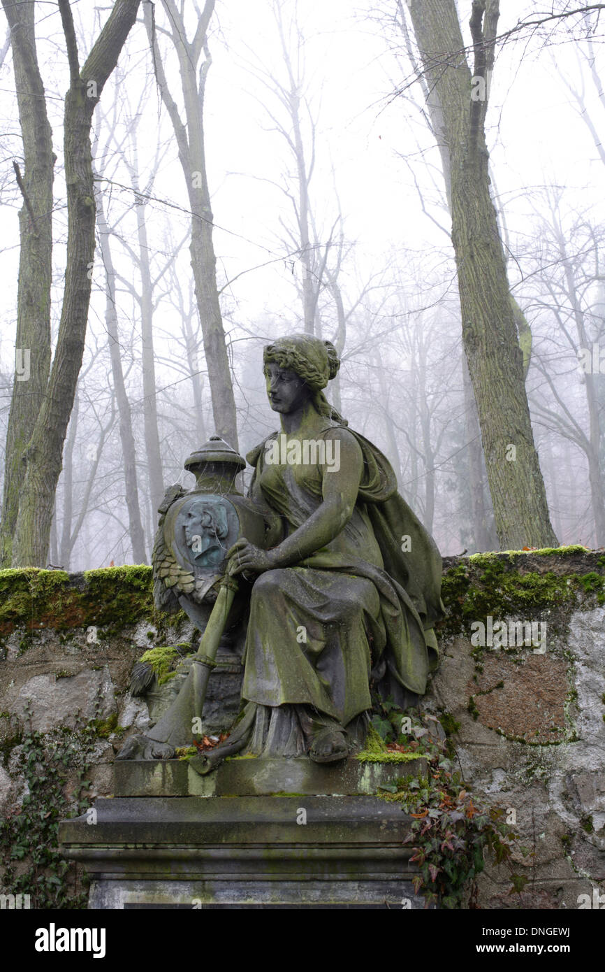 Vecchia tomba abbandonata con la statua di una donna Foto Stock