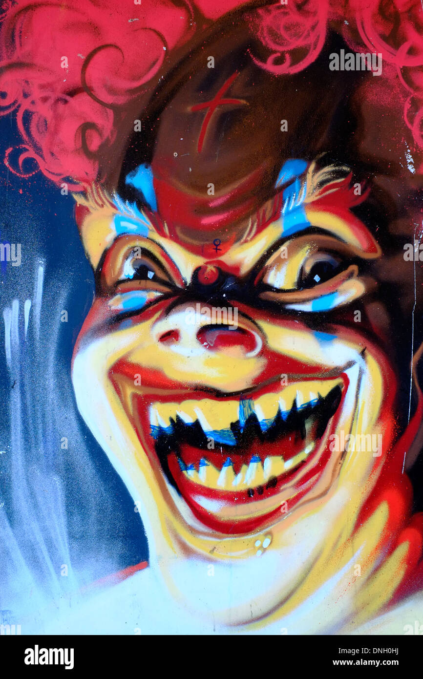 Strada decorativa arte dipinta su imbarco in legno raffigurante il male di ridere clown Foto Stock