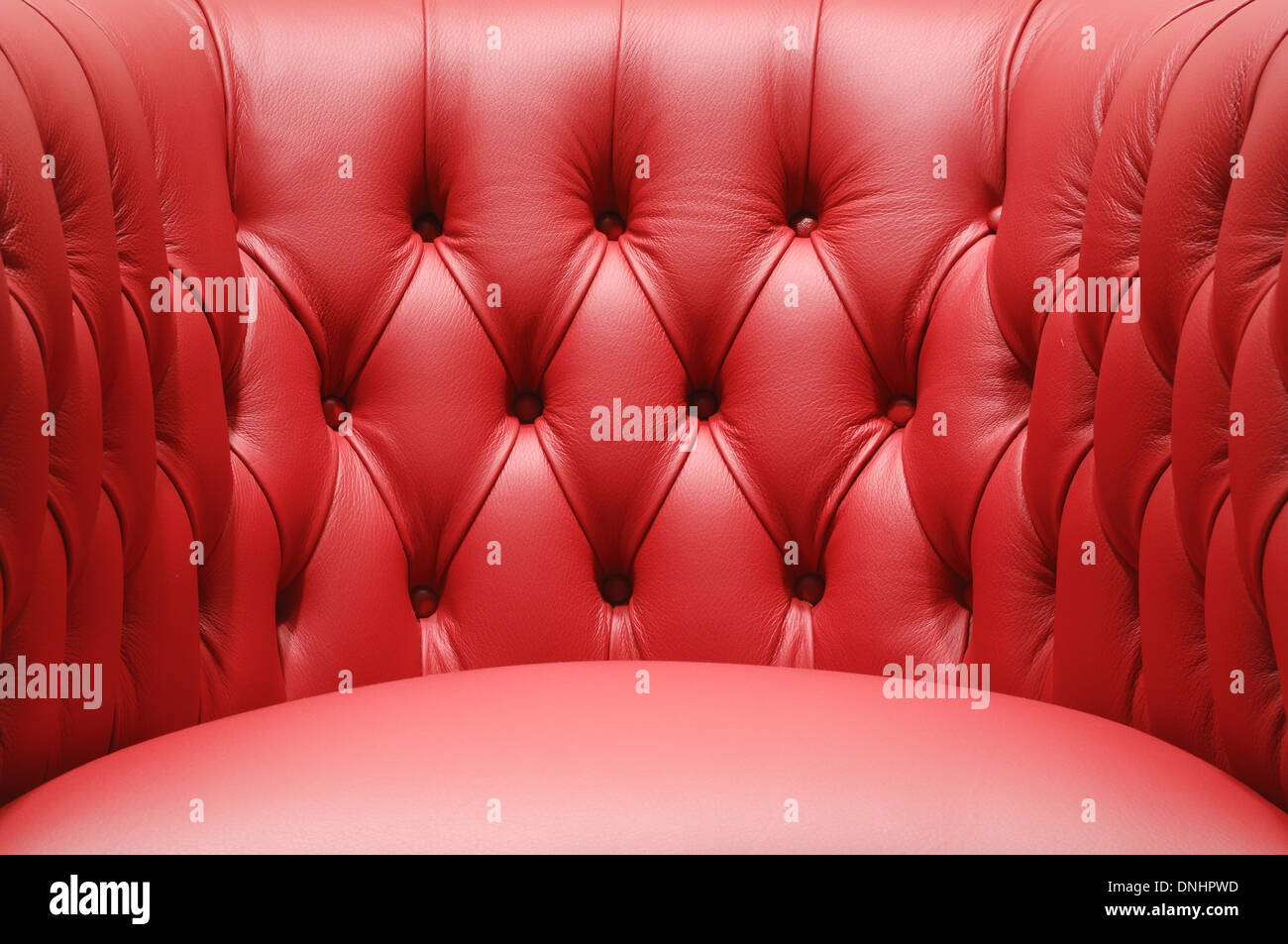 Una sezione di un rosso confortevole divano in pelle sedia mobili. Foto Stock