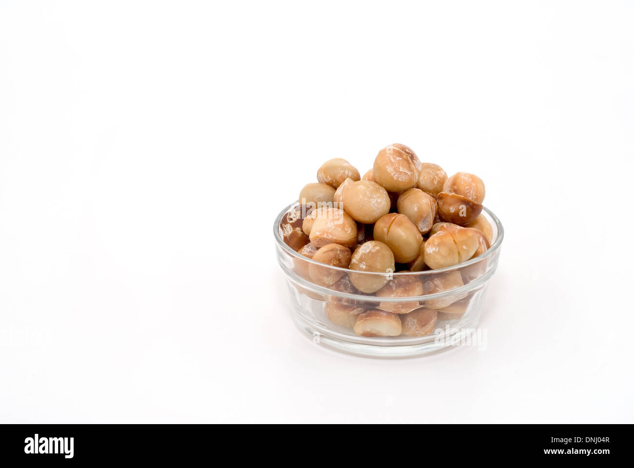 Carni arrosto di noci di Macadamia in recipiente di vetro - tagliare Foto Stock