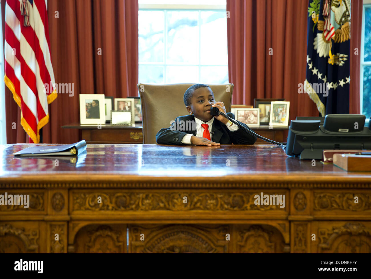 Robby Novak, la sensazione di YouTube noto come il capretto Presidente, finge una telefonata alla reception risoluto durante la sua visita a vedere il Presidente nell'Ufficio Ovale della Casa Bianca il 1 aprile, 2013 a Washington, DC. Foto Stock