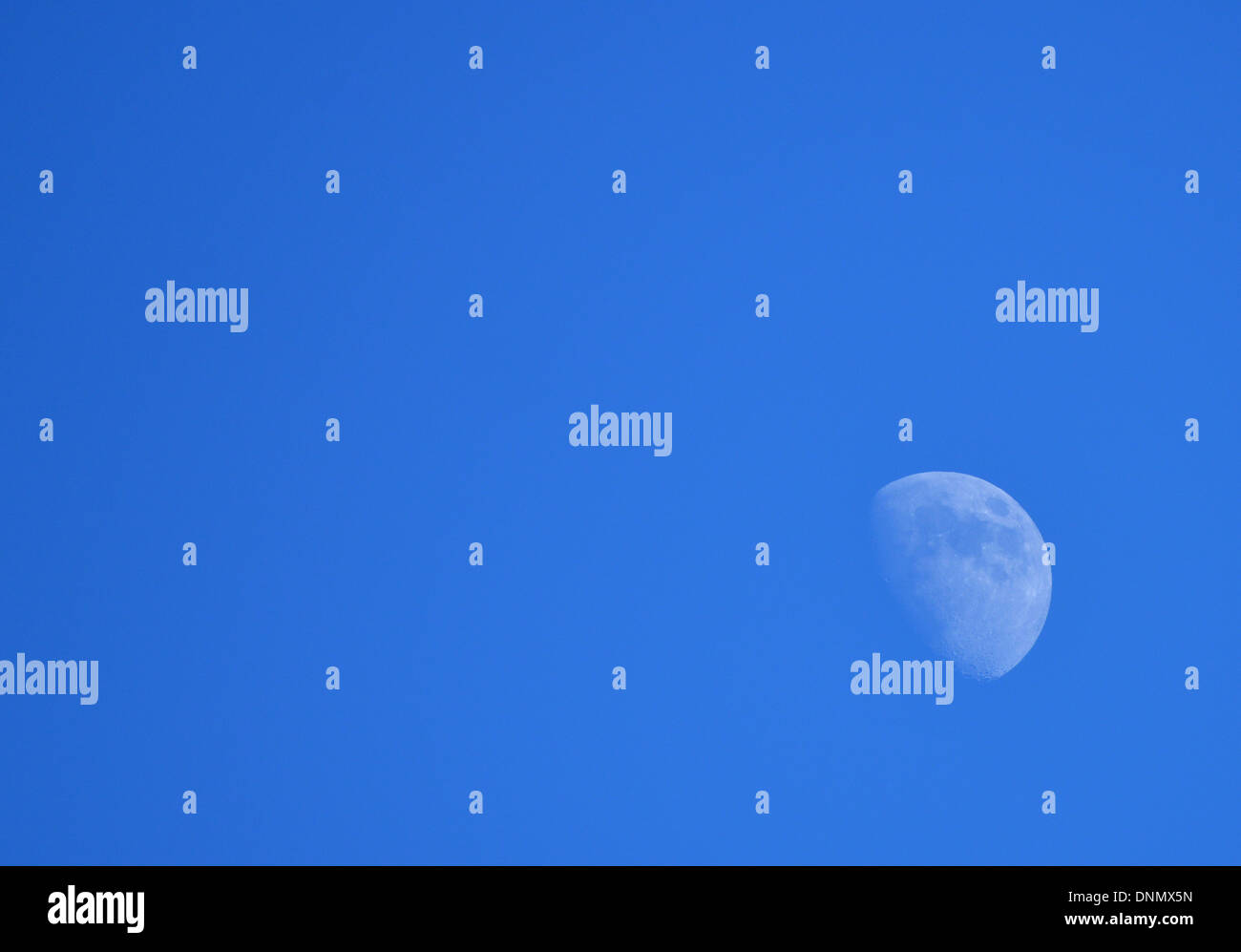 Half moon visibile in un blu brillante nel tardo pomeriggio sky, oltre Arizona USA Foto Stock