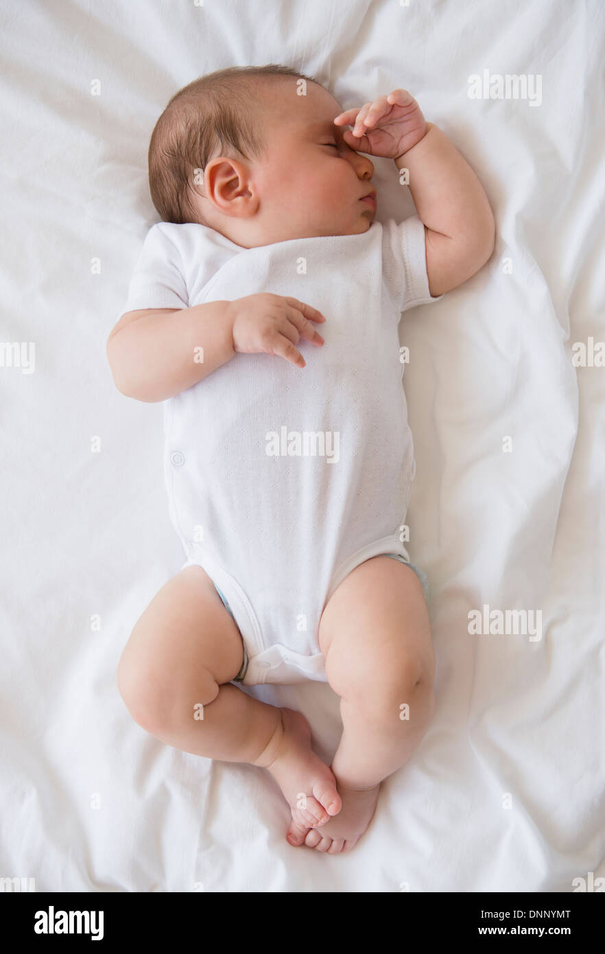 Baby girl (2-5 mesi) dormire nel letto Foto Stock