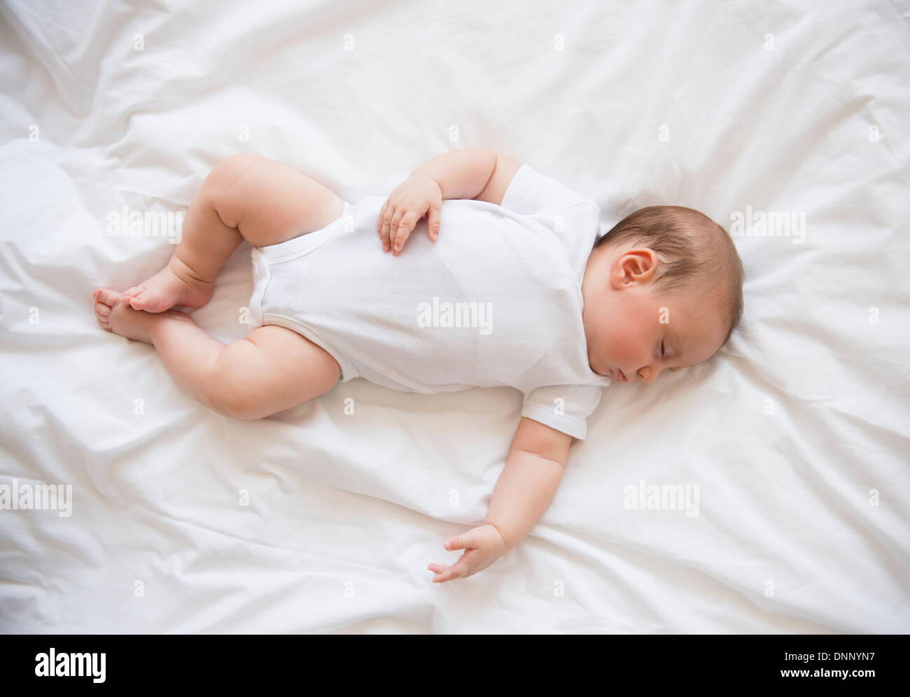 Baby girl (2-5 mesi) dormire nel letto Foto Stock