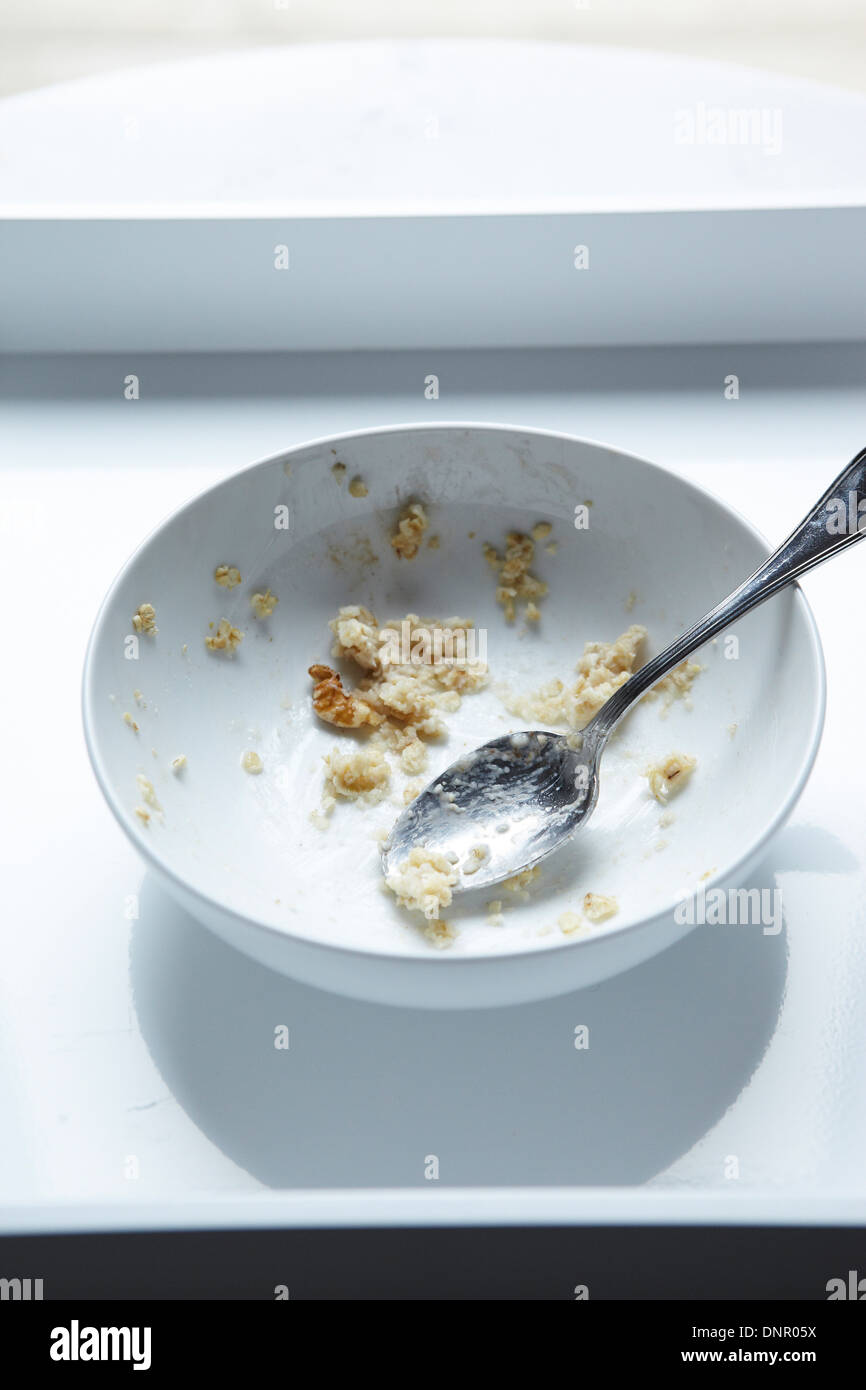 Cucchiaio in mangiato ciotola di fiocchi d'avena, Studio Shot Foto Stock