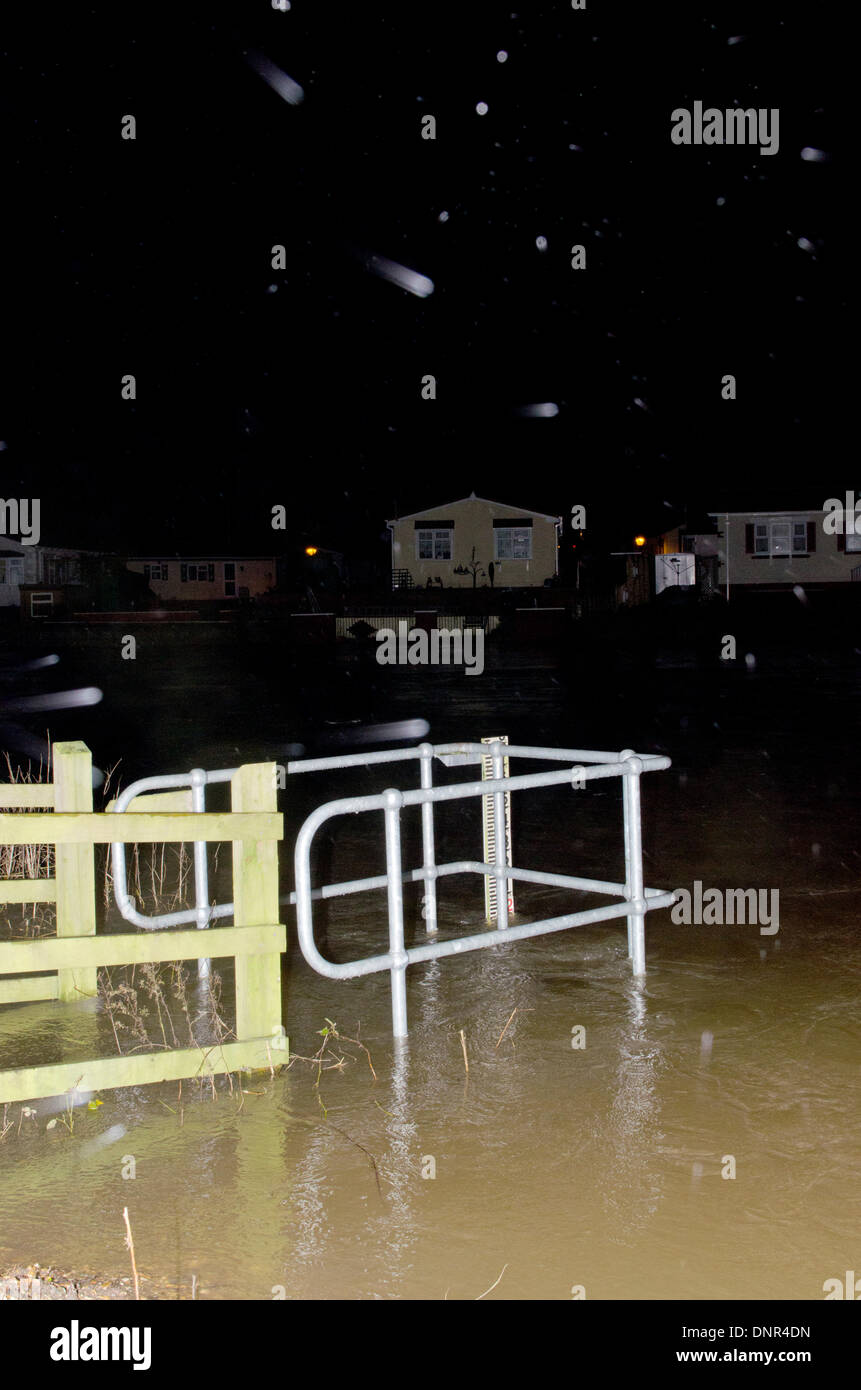 Iford, Christchurch, Dorset, Regno Unito . 02Jan, 2014. I residenti sono evacuati dal ponte Iford Home Park sito. I livelli di acqua sono in aumento con alte maree di 10:00 di domani mattina. Piove con heavy rain meteo durante la notte e l'agenzia per l'ambiente è di avvertimento più inondazioni. I residenti sono arrabbiati dopo supporto scarso e non dei sacchi di sabbia sul giorno di Natale alluvione. La strada le luci sono accese ma le case sono vuote e nelle tenebre. Credito: Roger Allen Fotografia/Alamy Live News Foto Stock
