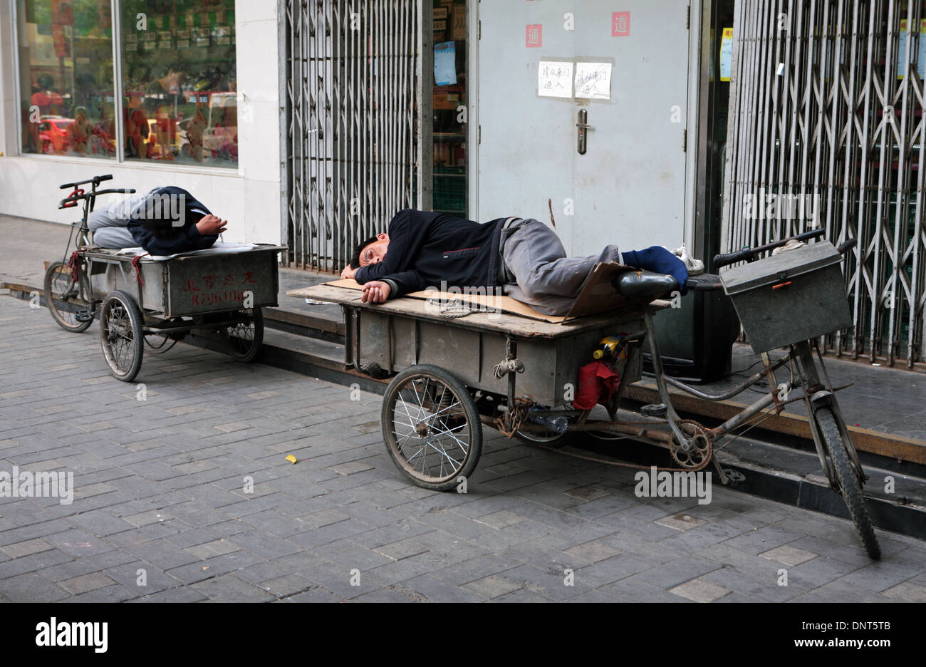 Sleeping bicicletta carrello uomini, Pechino, Cina. Foto Stock
