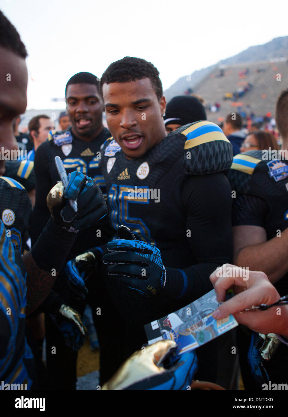 Dic. 31, 2013 - El Paso, TX, Stati Uniti d'America - 31 dicembre 2013 El Paso, TX...UCLA wide receiver (15) Devin Lucien ottiene pronto a firmare autografi dopo la UCLA vs Virginia Tech gioco di calcio. La UCLA Bruins sconfitto il Virginia Tech Hokies 42-12 Martedì, Dicembre 31, 2013 in Hyundai Sun Bowl a El Paso, TX. (Obbligatorio Credito: Juan Lainez / MarinMedia.org / Cal Sport Media) (completare il fotografo e il credito richiesto) Foto Stock