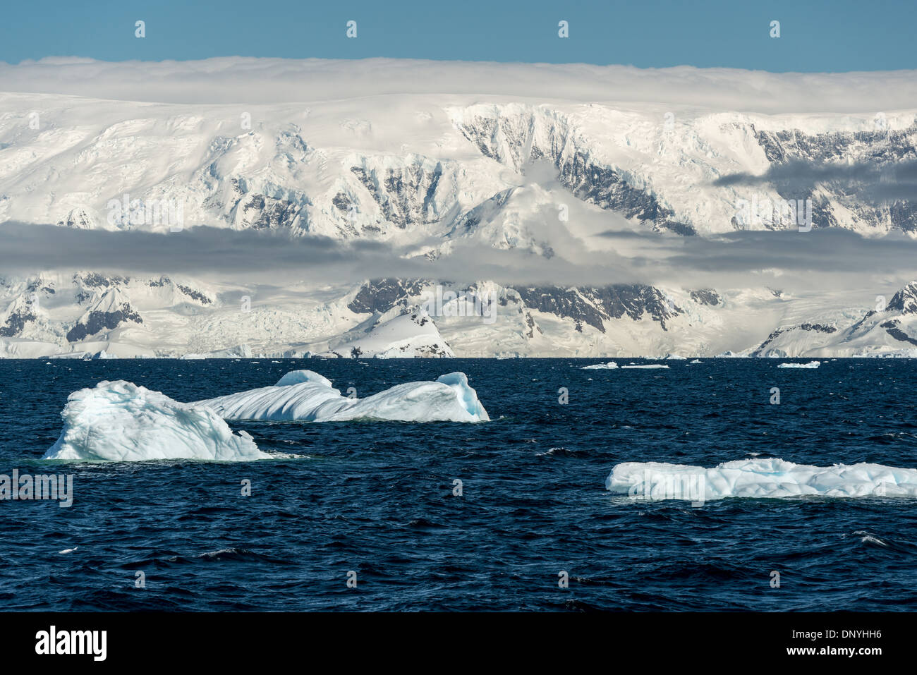 Antartide - Drammatico la neve e il ghiaccio sulle montagne ricoperte di sollevarsi dal litorale del Gerlacht stretto sulla costa occidentale della penisola antartica. Foto Stock