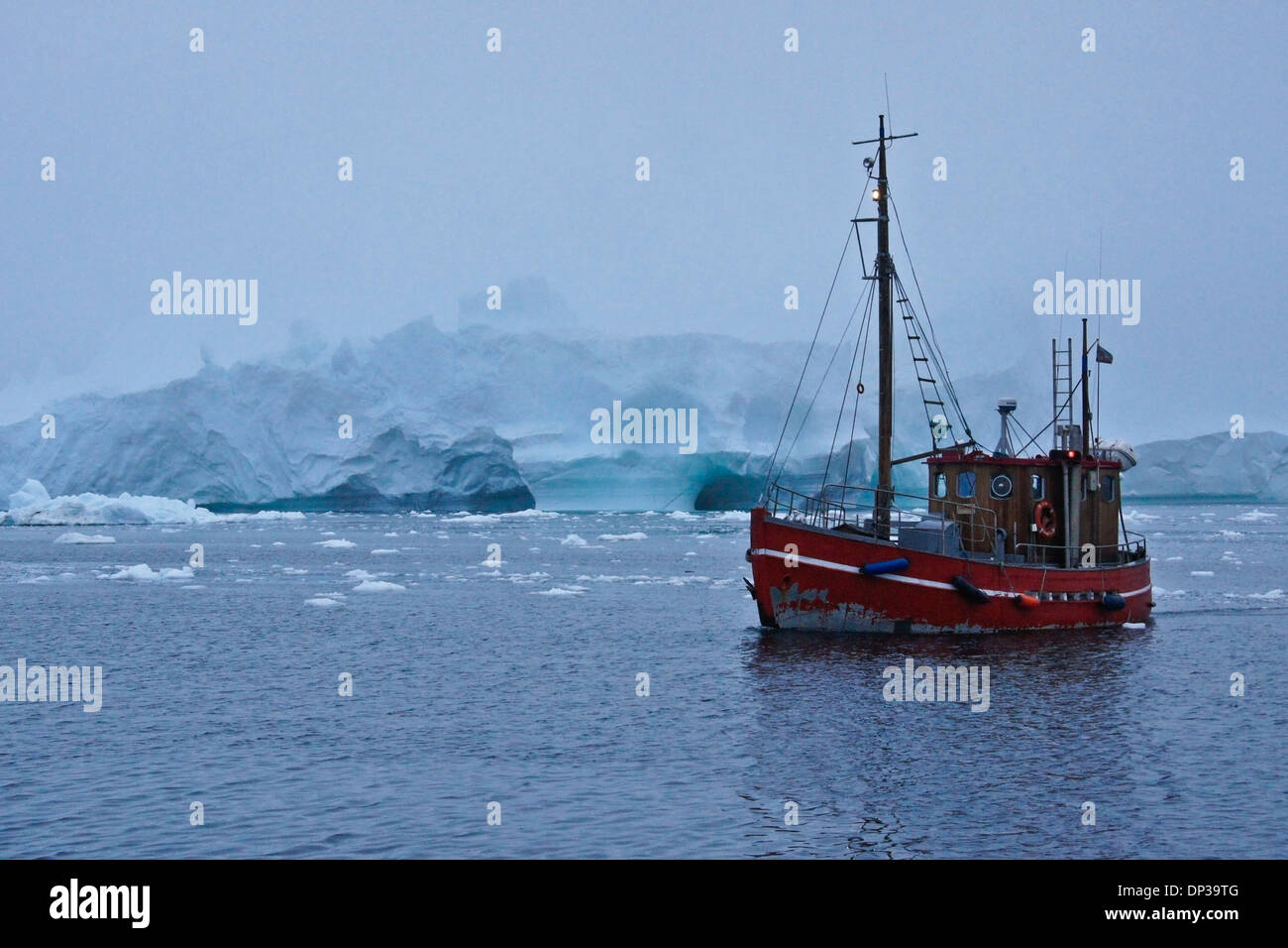 La pesca in barca tra gli iceberg nella nebbia, Disko Bay, Ilulissat, Groenlandia occidentale Foto Stock