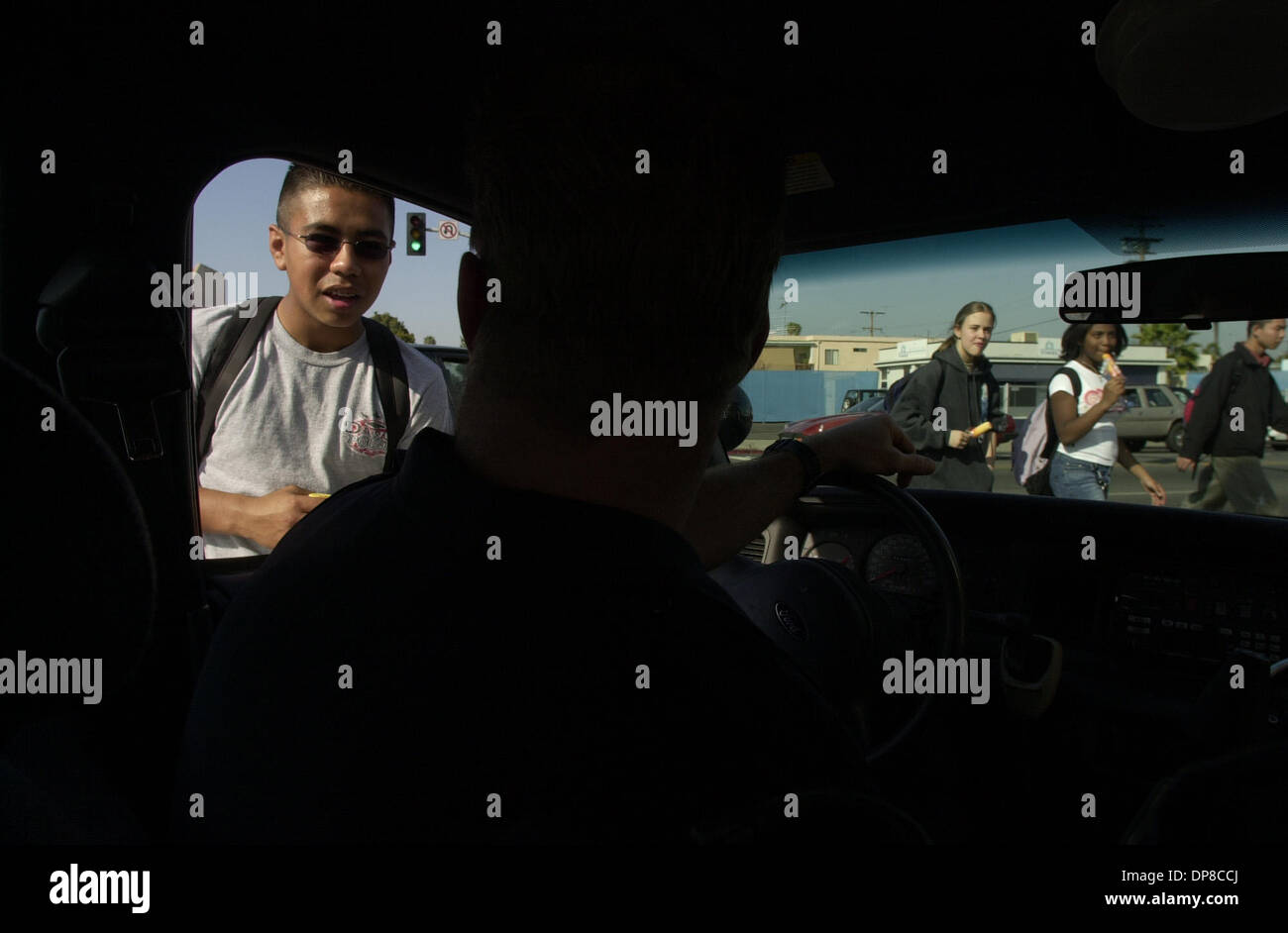 (Pubblicato il 20/04/2003; E-1:1,2,3) Ruben Cruz, 15, si ferma a parlare con Sgt. Andrew Hoffman in città altezze sul suo modo a casa da scuola. Hoffman utilizza ogni occasione per mettere in pratica il suo spagnolo con le persone della comunità. Parole chiave: Veicoli a motore. La polizia. Peggy Peattie foto Foto Stock
