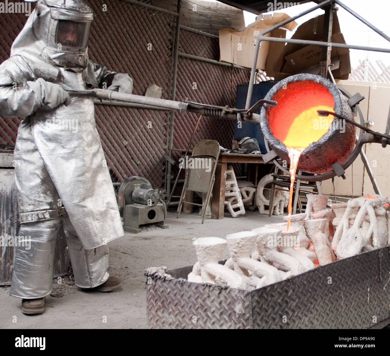 Burbank, in California, Stati Uniti d'America. Il 9 gennaio, 2014. Abili artigiani hanno portato dal maestro fondatore Enrique Guerrero presso la American Fine Arts Fonderia di Burbank versata alcune delle ultime statuette di premio per questo anni Screen Actors Guild Awards che si terrà il 18 gennaio 2014. Il 16 pollici di altezza 12 pound statuette, realizzata in bronzo massiccio con un venduto base di granito nero, sono ammessi a raffreddarsi prima che lo stampo realizzato dall'perso è stato processo viene rimosso e le statuine sono cesellata in 2 ore di processo di pulizia e preparato prima della finale di finitura verdigris è applicato. Credito: ZUMA Press, Inc./Alamy Live News Foto Stock