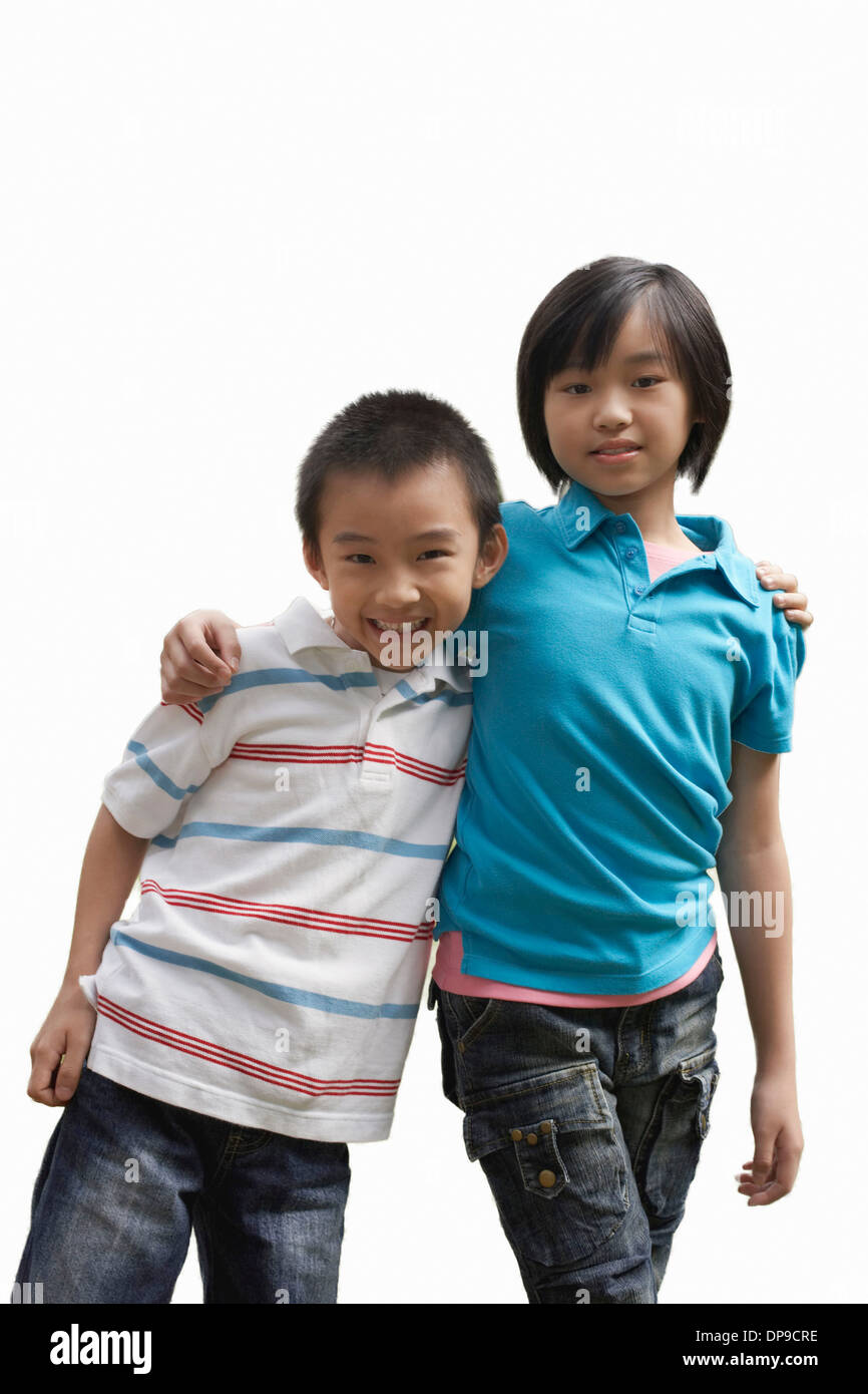 Ritratto di fratello e sorella in piedi contro uno sfondo bianco Foto Stock