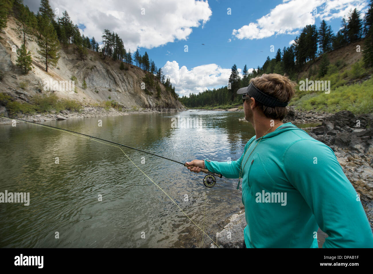 Uomo di pesca a mosca nel fiume Clark Fork in Montana. Foto Stock