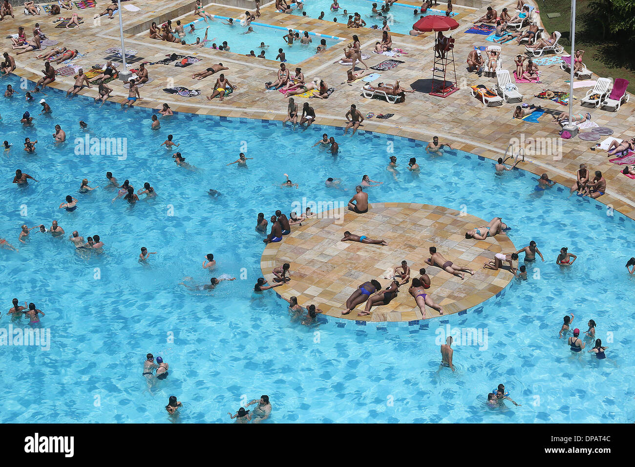 Sao Paulo, Brasile. Xi gen, 2014. Le persone godono di una calda giornata estiva in Sesc Belenzinho in Sao Paulo, Brasile, il 10 gennaio, 2014. Secondo il Centro per le previsioni meteorologiche e studi sul clima (Cptec) e Istituto Nazionale per la ricerca spaziale (INPE), il paese potrebbe raggiungere livelli estremi di radiazione UV indice che è nocivo per la salute il venerdì e nei giorni seguenti. Si stima che ogni anno vi sono circa 120.000 nuovi casi di cancro della pelle in Brasile, secondo le notizie riportate dalla stampa locale. © Rahel Patrasso/Xinhua/Alamy Live News Foto Stock