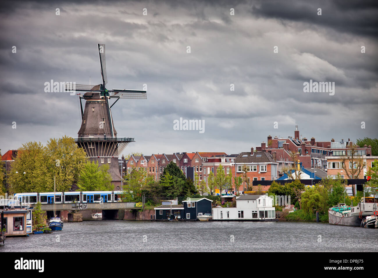 Il Gooyer Windmill e case dal canale, città di Amsterdam, Olanda Settentrionale, Paesi Bassi. Foto Stock