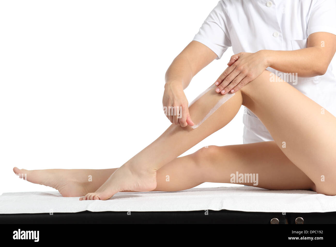 Estetista ceretta una bella donna liscia gambe con una striscia di cera isolata su uno sfondo bianco Foto Stock