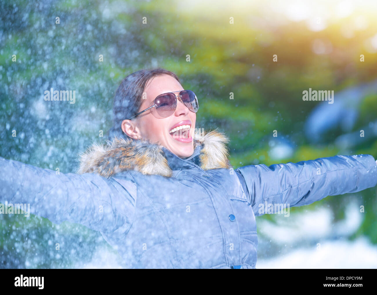 Giocoso donna divertirsi sul winter park, gettando la neve, godendo inverno natura, uno stile di vita attivo, il concetto di felicità Foto Stock