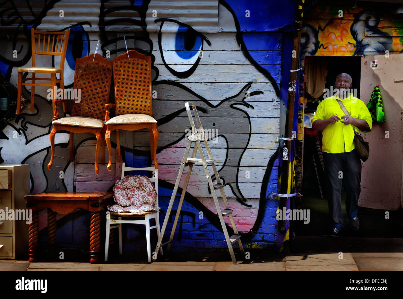 L'uomo la vendita di seconda mano mobili su strada Brick Lane area, East London REGNO UNITO Foto Stock