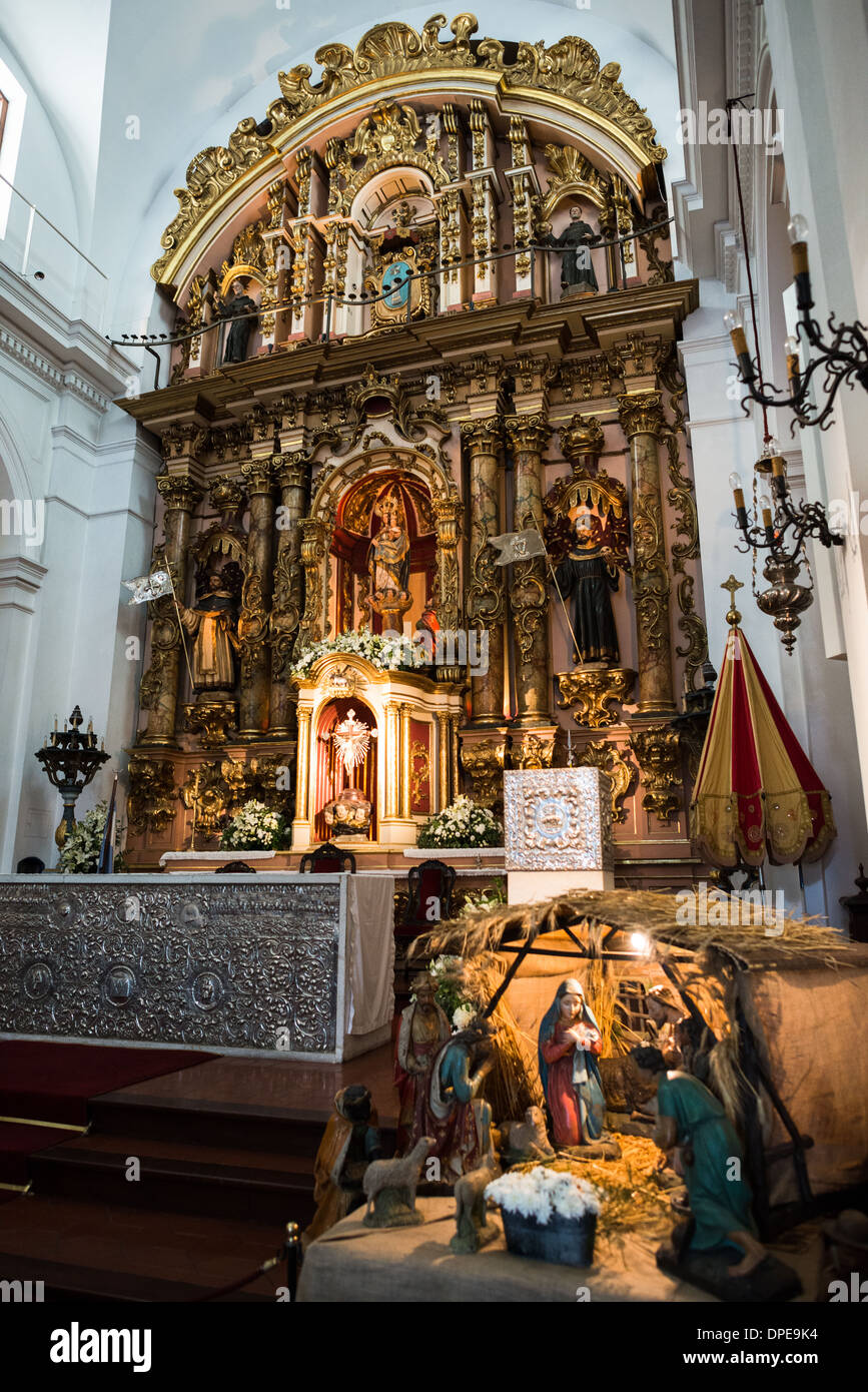 BUENOS AIRES, Argentina - l'altare principale barocco della Basílica de Nuestra Señora del Pilar presenta il suo design originale del XVIII secolo con ornamenti inca e argenteria peruviana. Una tradizionale scena di presepe occupa lo spazio in primo piano prima dell'altare. Questo altare storico, risalente alla costruzione della chiesa del 1732, rimane uno dei migliori esempi di arte religiosa coloniale di Buenos Aires. Foto Stock