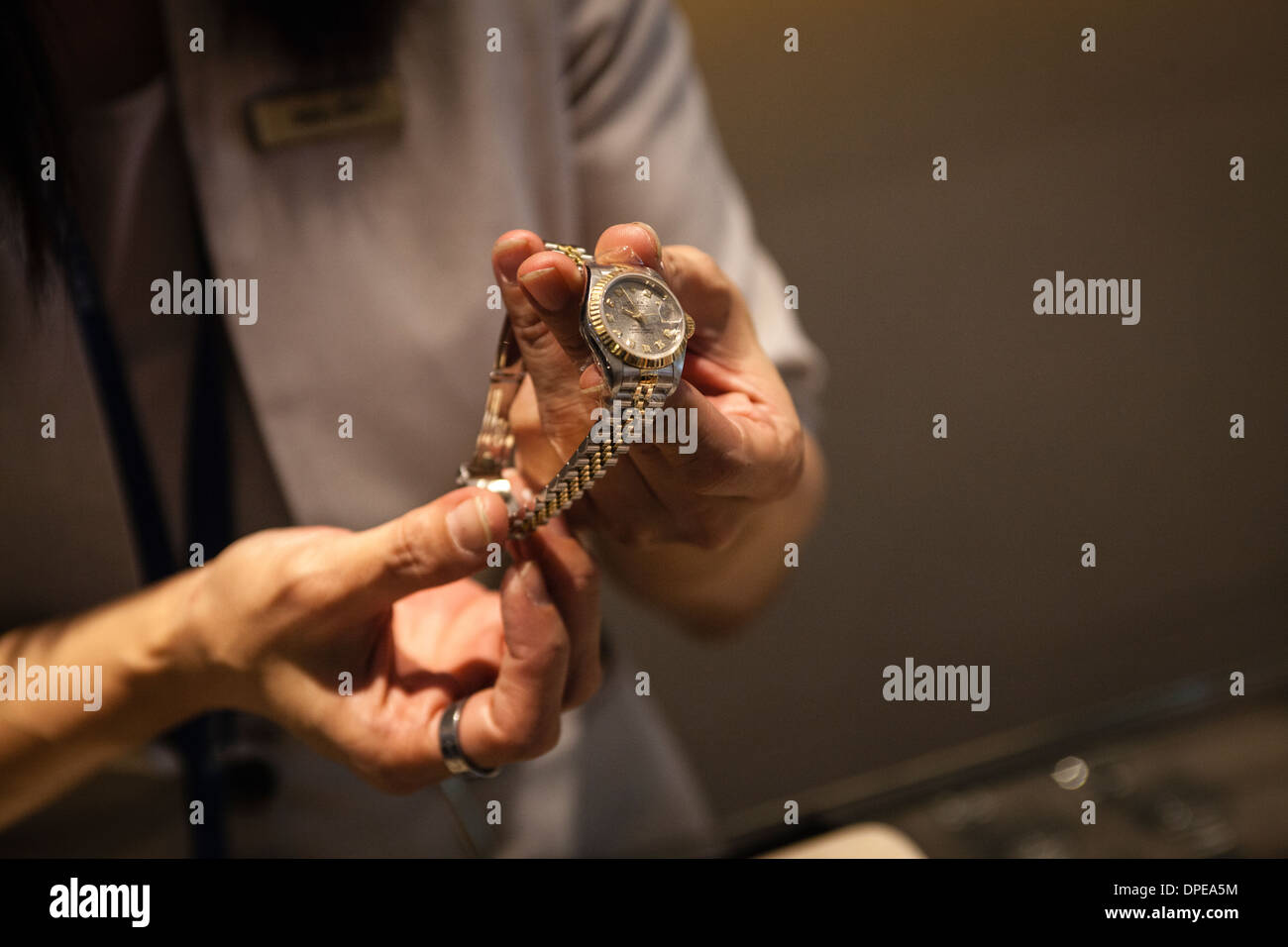 Un addetto alle vendite può contenere fino a impegnati orologio Rolex  presso una filiale di Maxi-Cash pedina di intermediazione in Singapore Foto  stock - Alamy