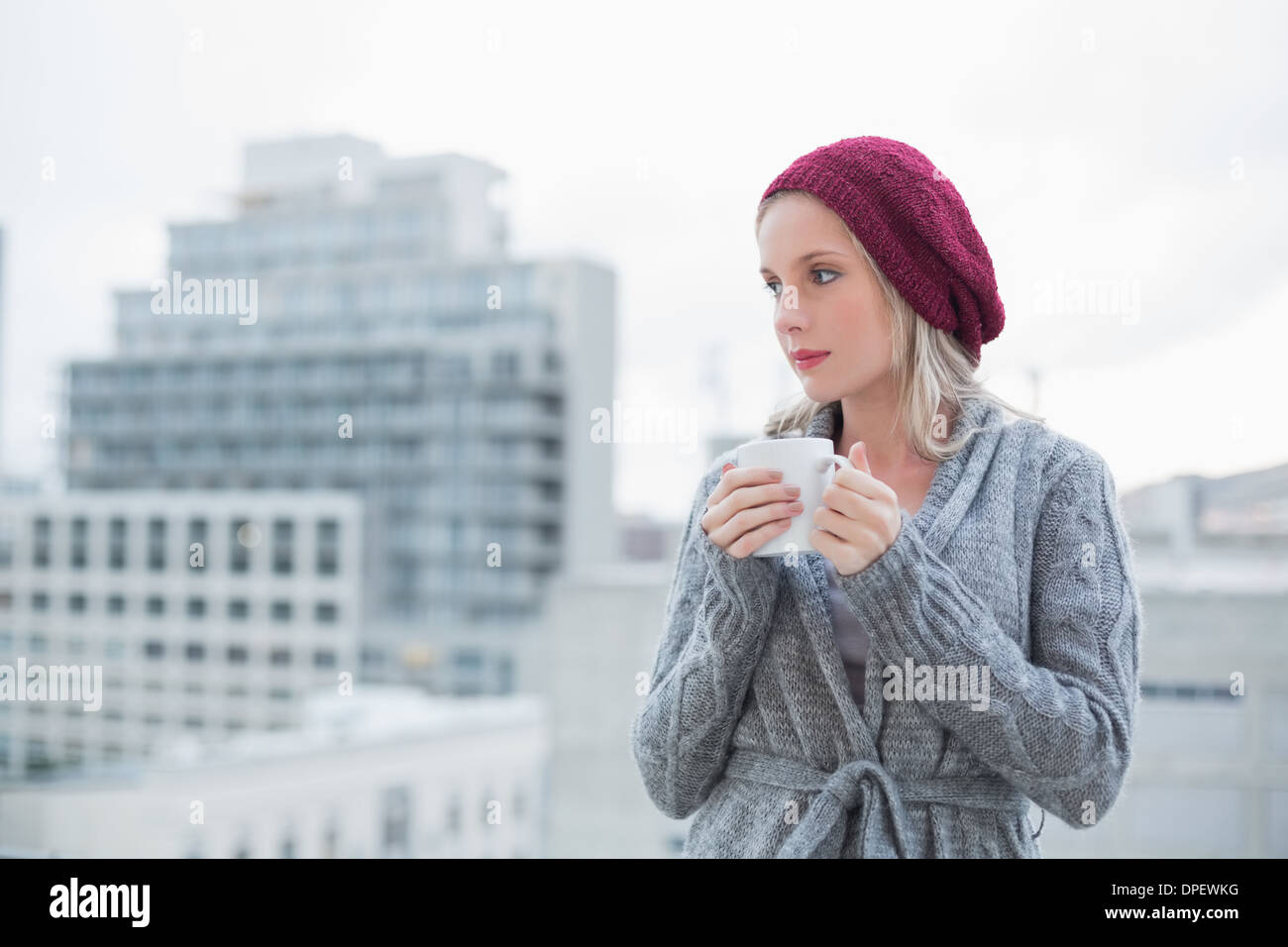 Pensare una splendida bionda di bere il caffè all'aperto Foto Stock