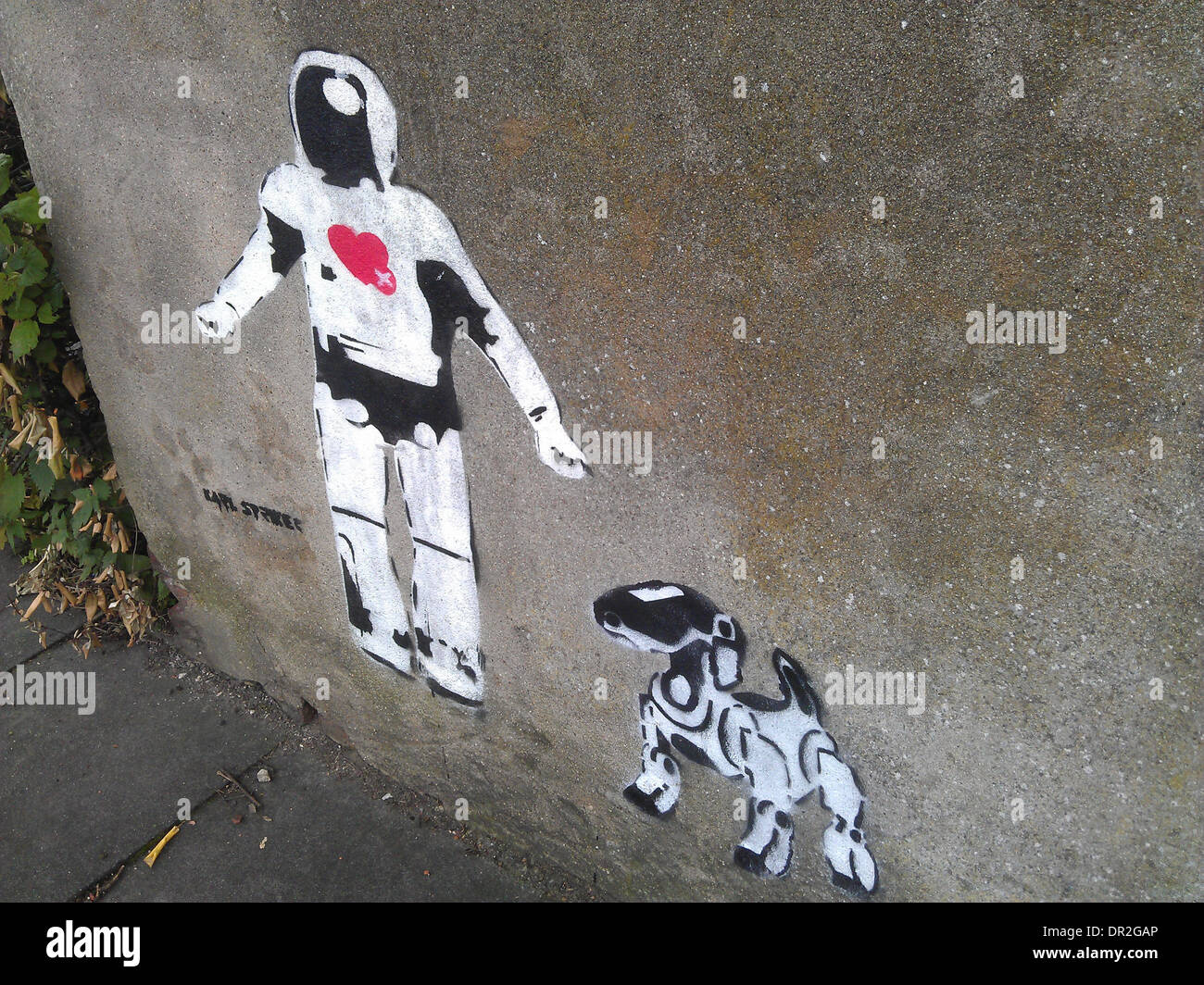 I graffiti sulla parete del robot androide e cane robotico Foto Stock