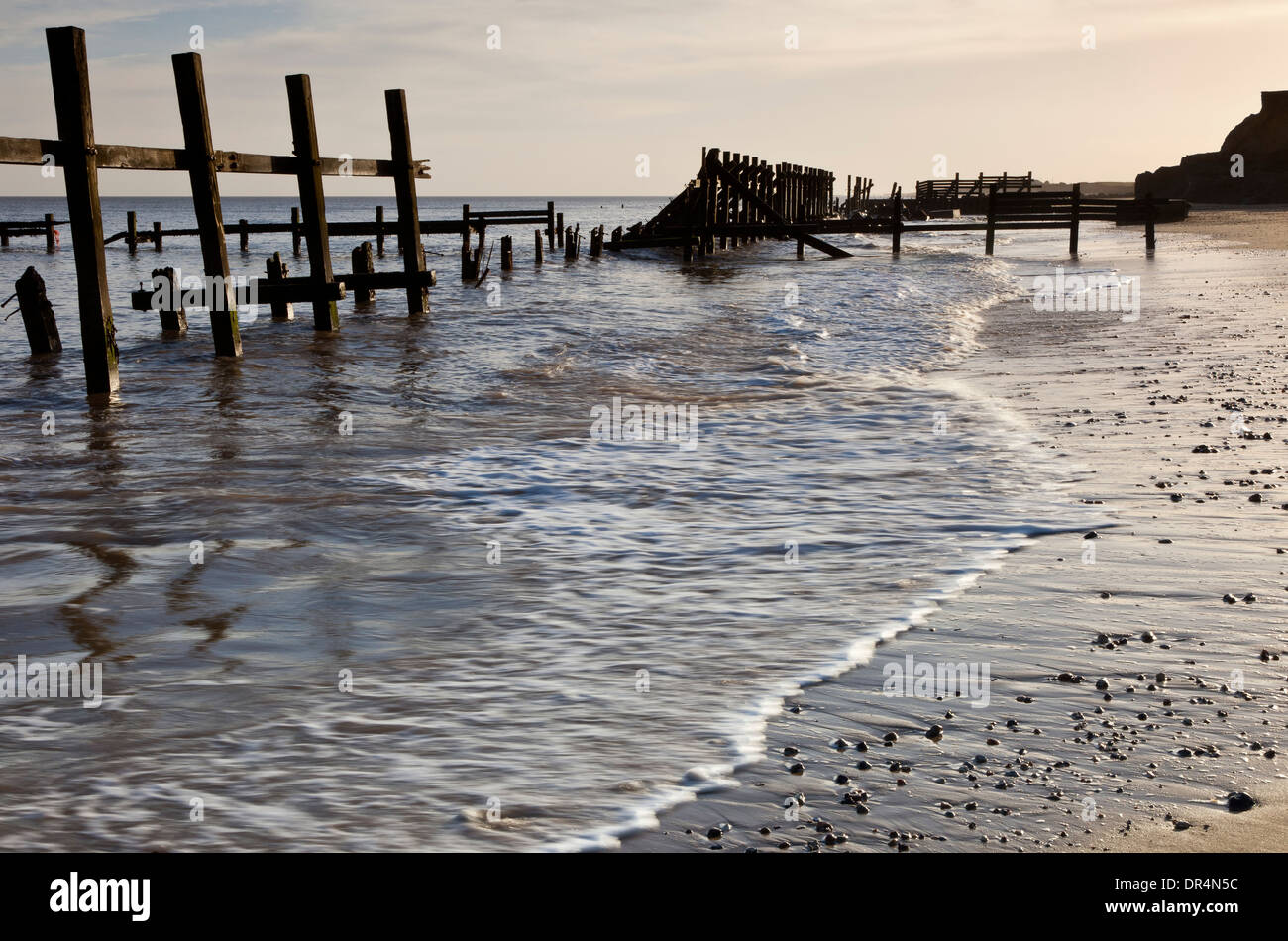 Tempesta danneggiato le difese di mare sulla spiaggia di Happisburgh in Norfolk Inghilterra Foto Stock