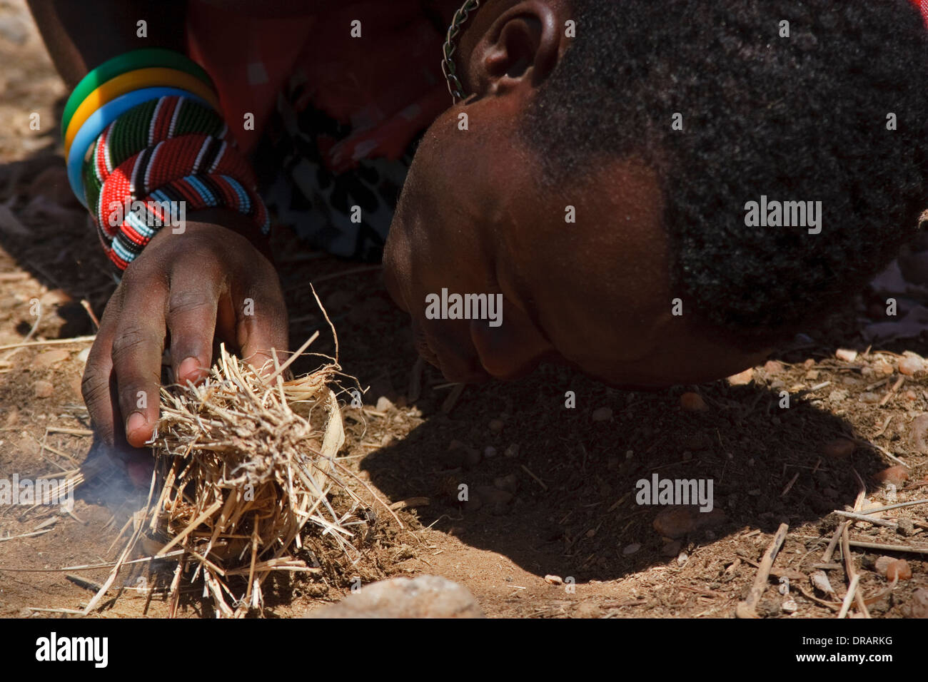 Maschio da Samburu tribù in un Samburu borgo fa fuoco Foto Stock