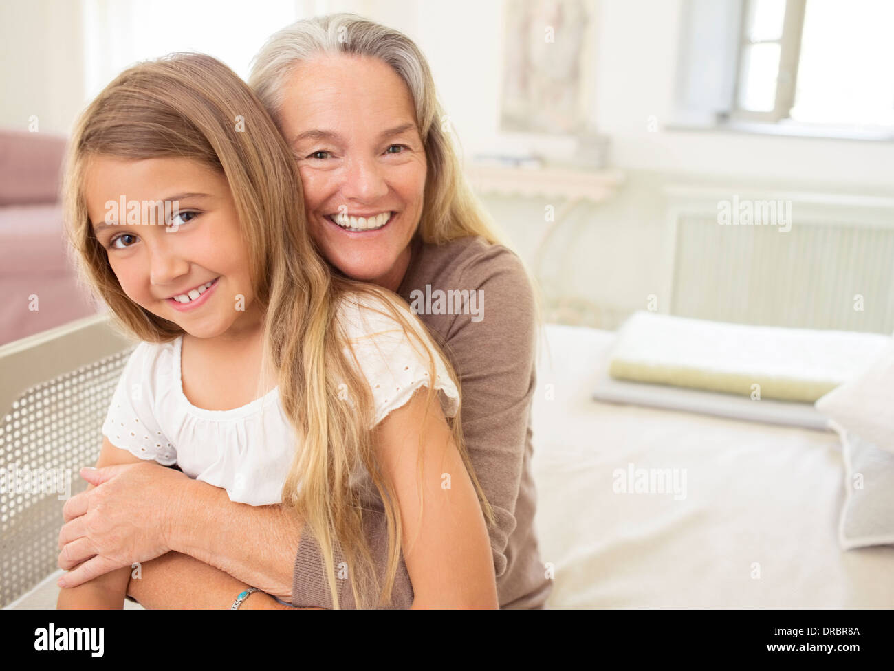 Nonna abbracciando la nipote Foto Stock
