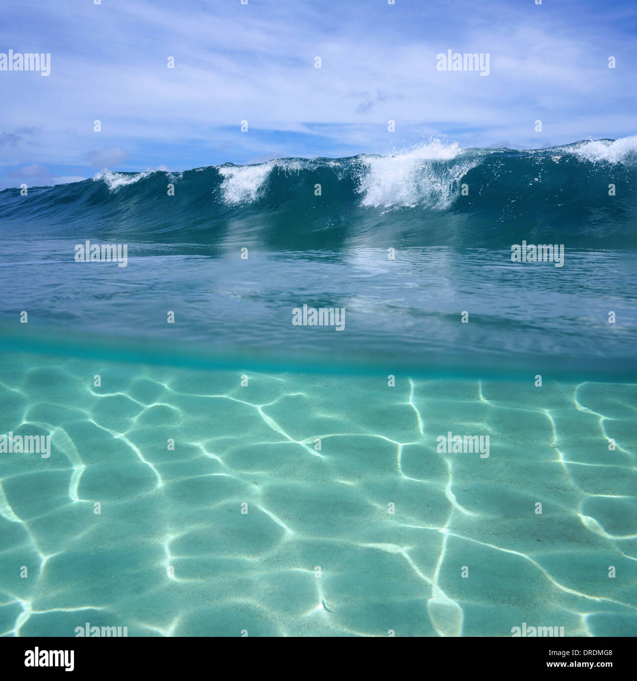 Vista separata delle onde dell'oceano e dei fondali marini sabbiosi sott'acqua Foto Stock