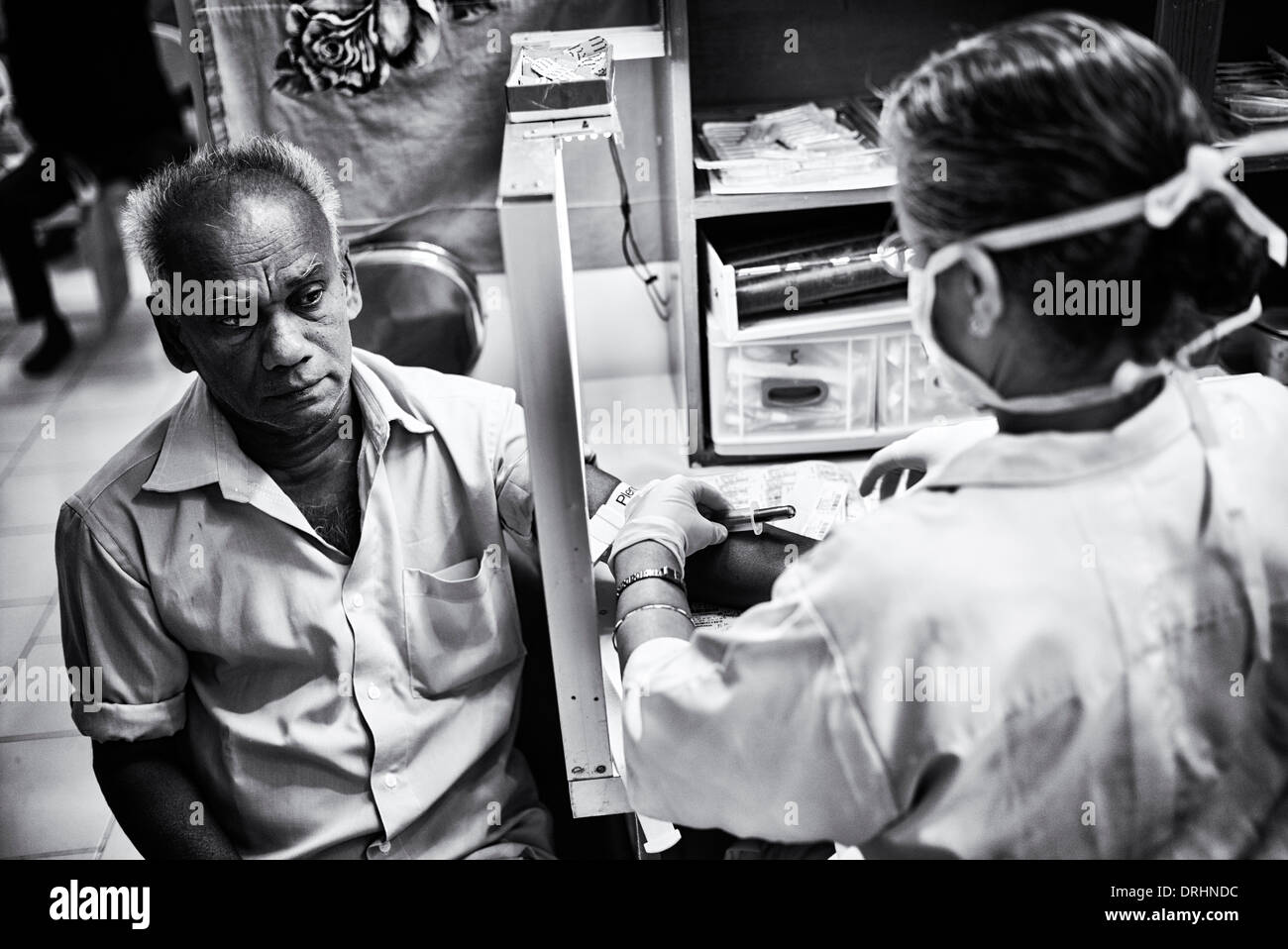 Uomo indiano dando un campione di sangue in laboratori a Sathya Sai Baba Super Specialty hospital. Puttaparthi, Andhra Pradesh, India Foto Stock