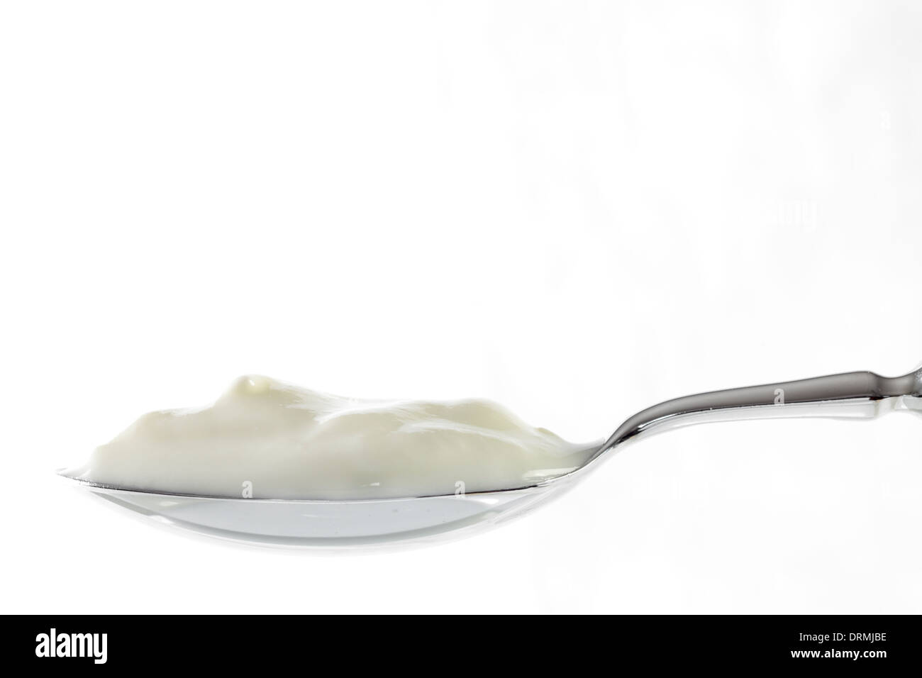 Cucchiaio colmo di yogurt Foto Stock