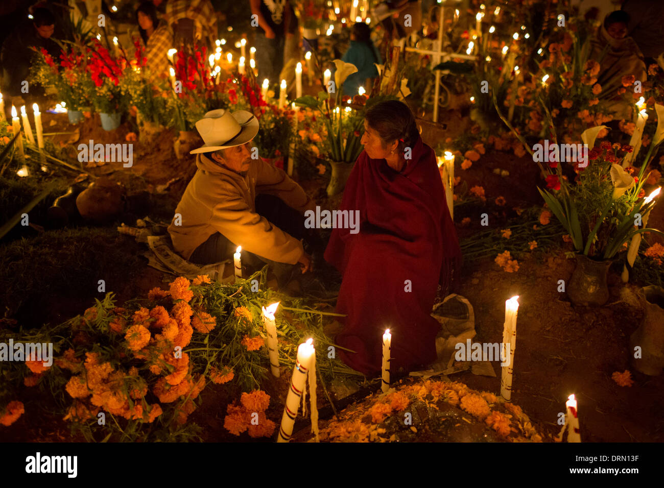 Una famiglia spende la notte che accompagna la tomba di uno dei loro parenti morti. Foto Stock