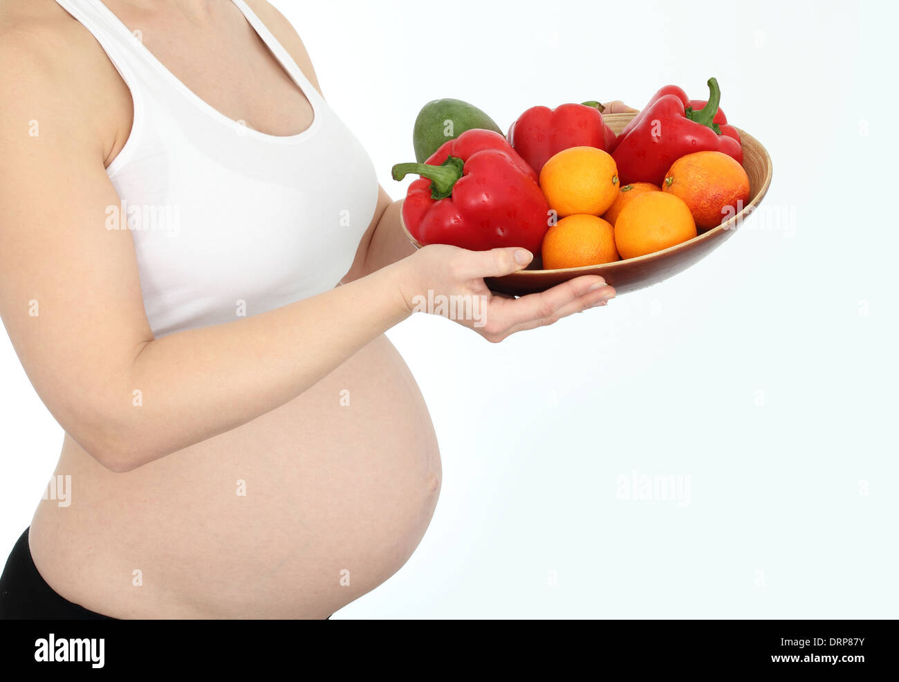 Donna incinta con frutta e verdura ciotola Foto Stock