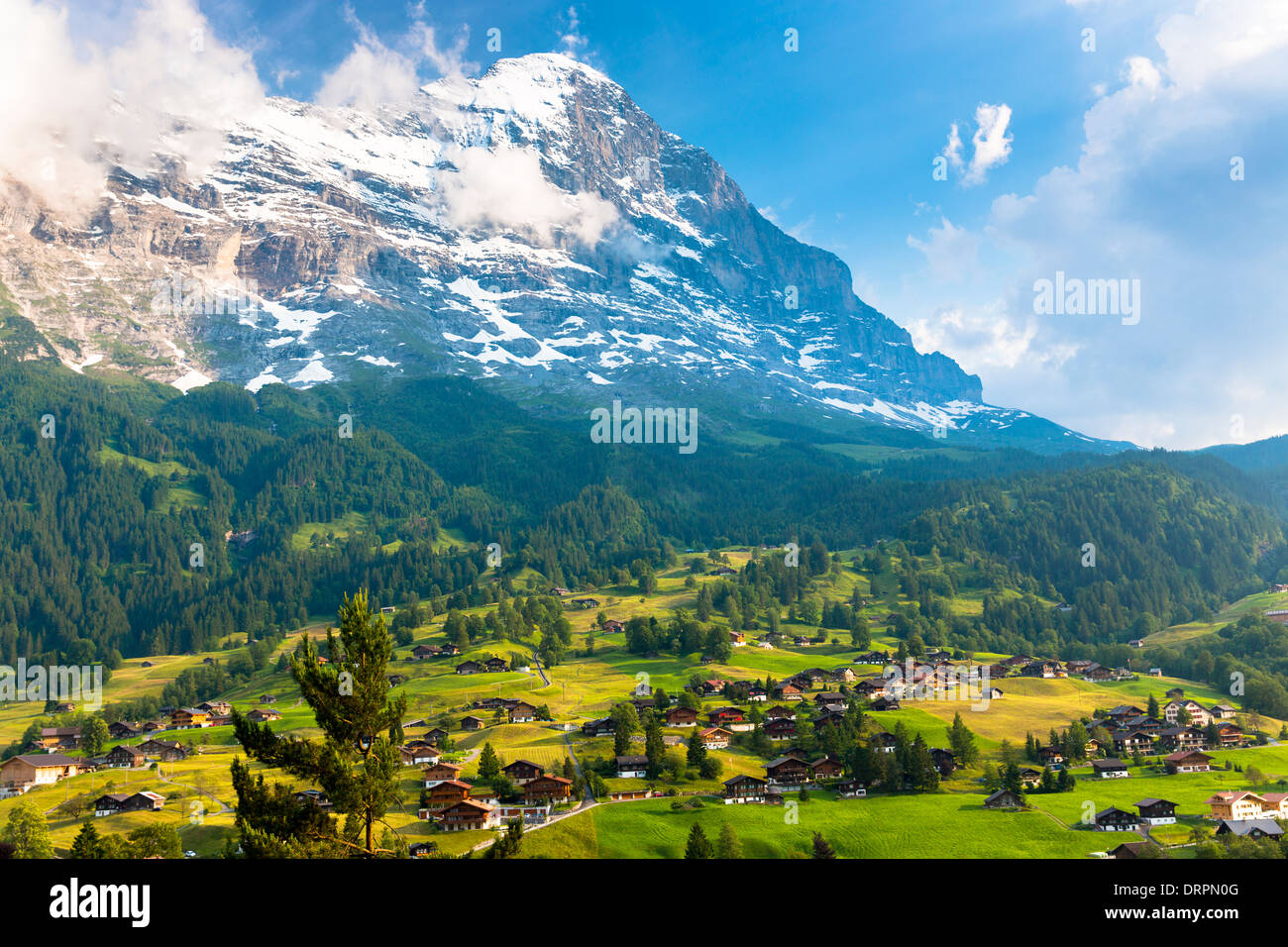 La città di Grindelwald, sotto la montagna dell'Eiger, si trova a nord sotto il cielo ceruleo delle Alpi svizzere nell'Oberland bernese, in Svizzera Foto Stock