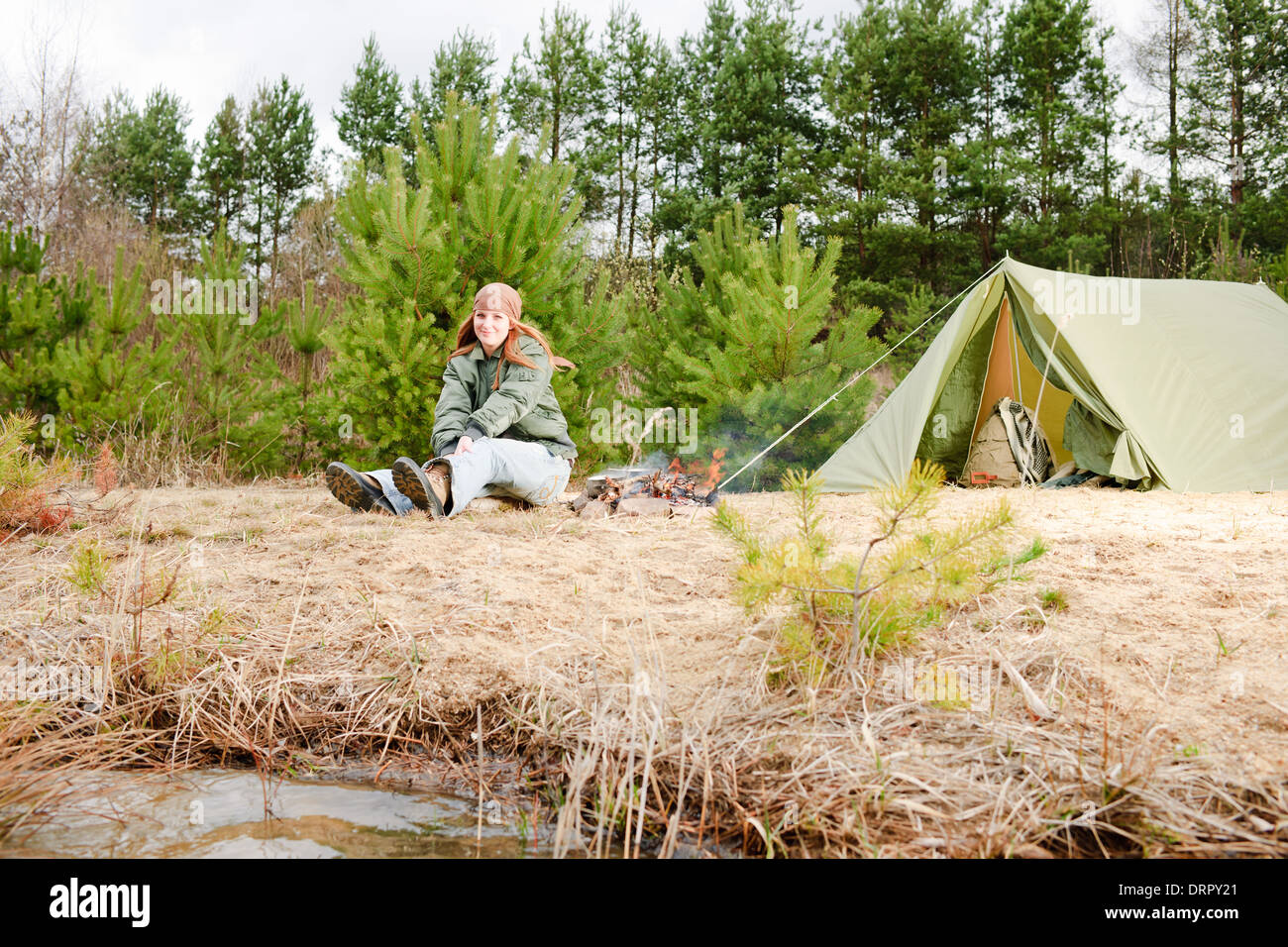 Campeggio tenda donna seduta fire natura Foto Stock